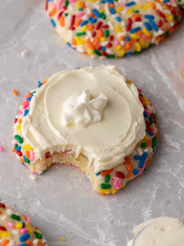 Crumbl funfetti milkshake cookie with a bite taken out of it