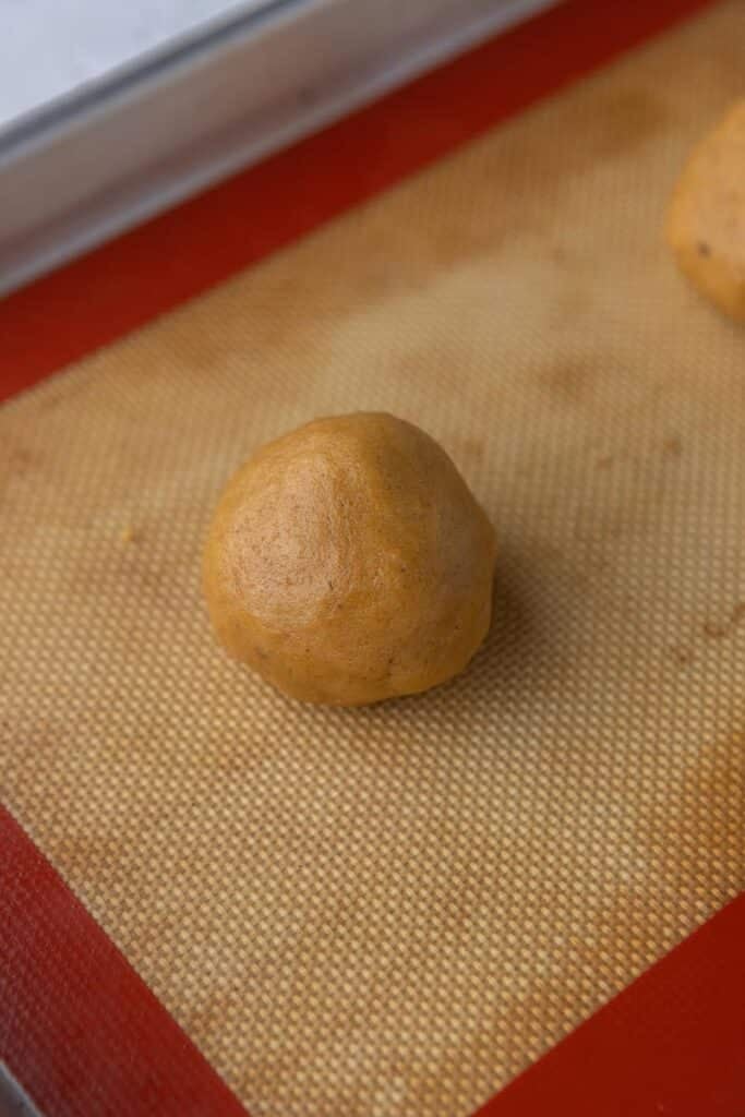 Pumpkin cookie dough on baking sheet