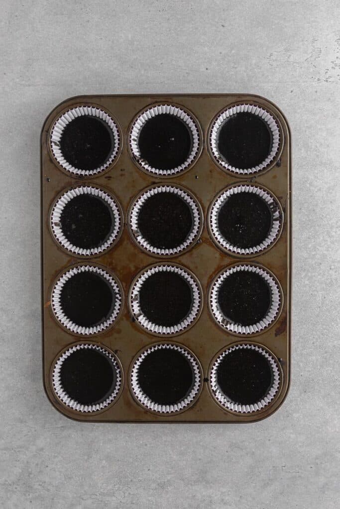 black cupcakes in a muffin tin