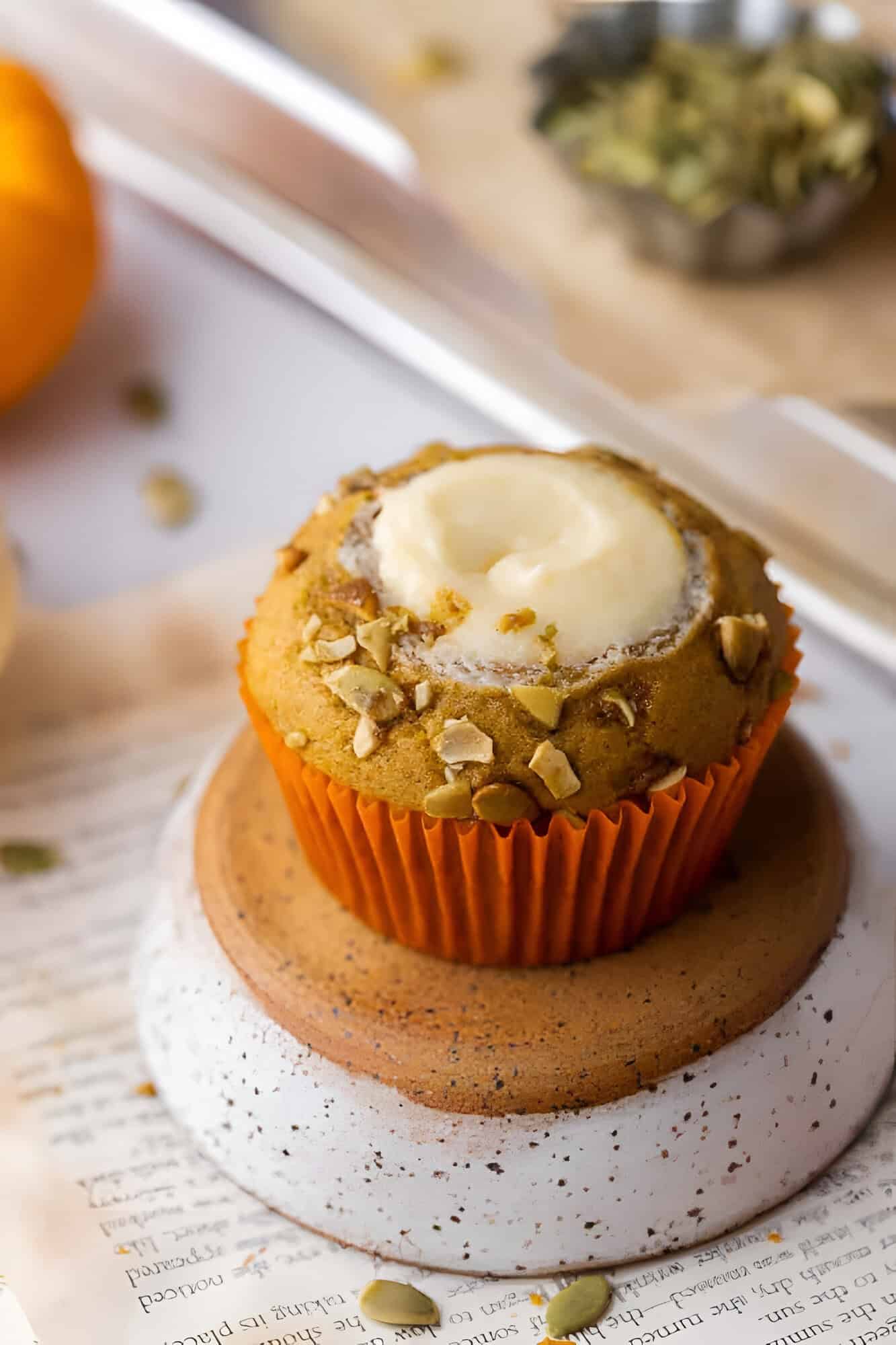 Starbucks pumpkin cream cheese muffin showing the thick white cream cheese center inside.