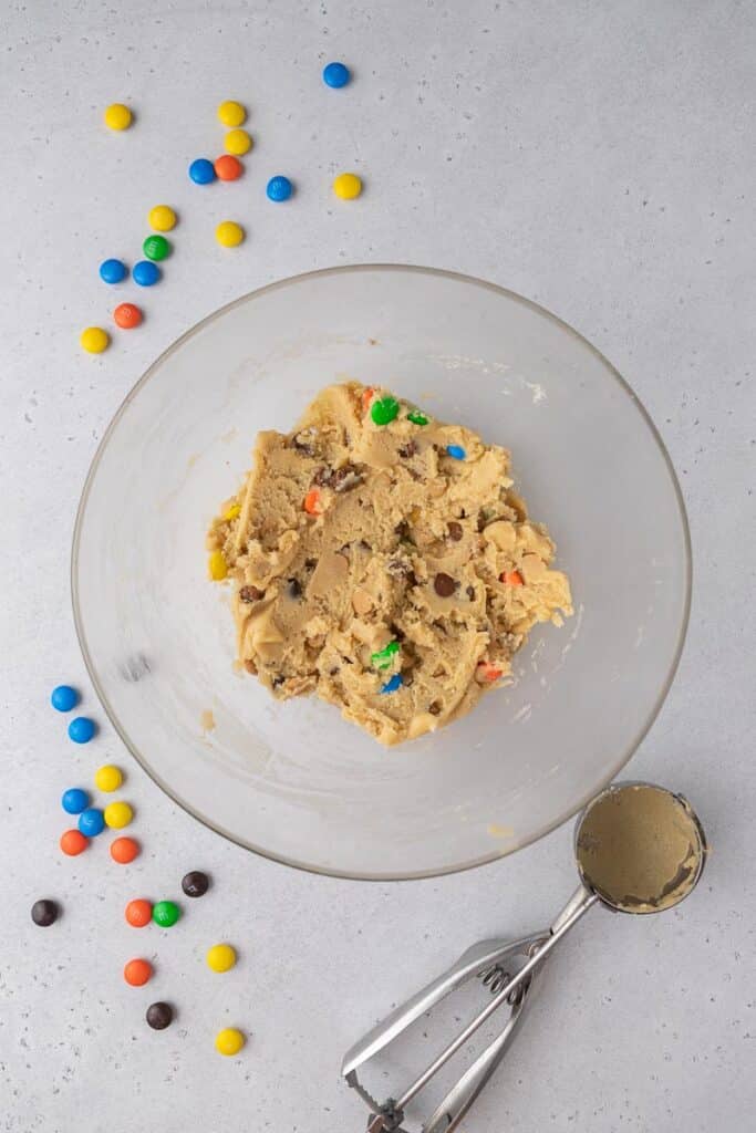 Cookie dough with m&M's, peanut butter chips, and chocolate chips in a bowl