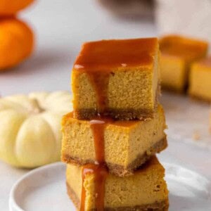 Stack of pumpkin cheesecake bars with caramel