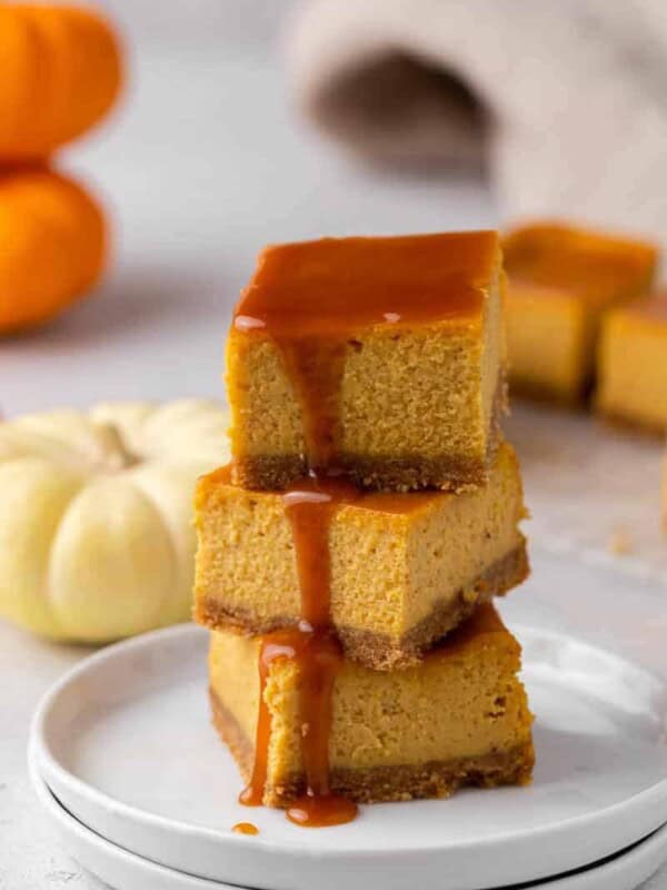 Stack of pumpkin cheesecake bars with caramel