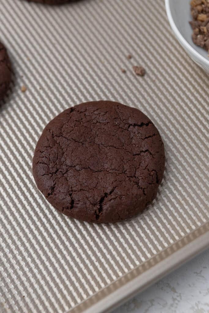 Baked chocolate cookie on baking sheet