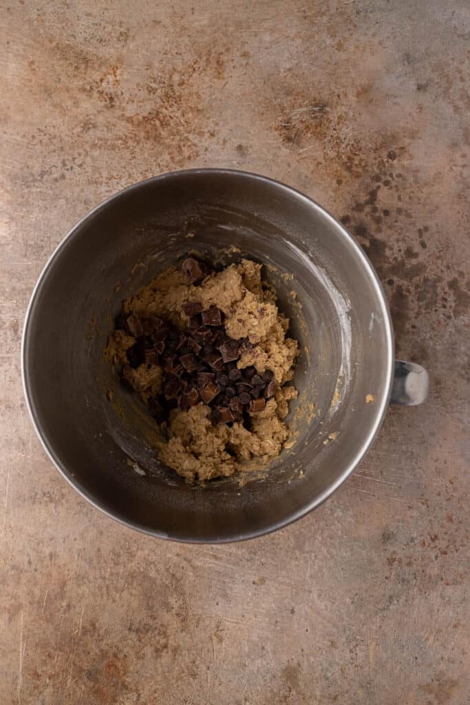 Cookie dough with chocolate chips in mixing bowl