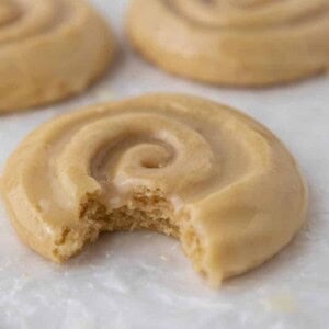 Crumbl honey bun cookie with a bite taken out of it