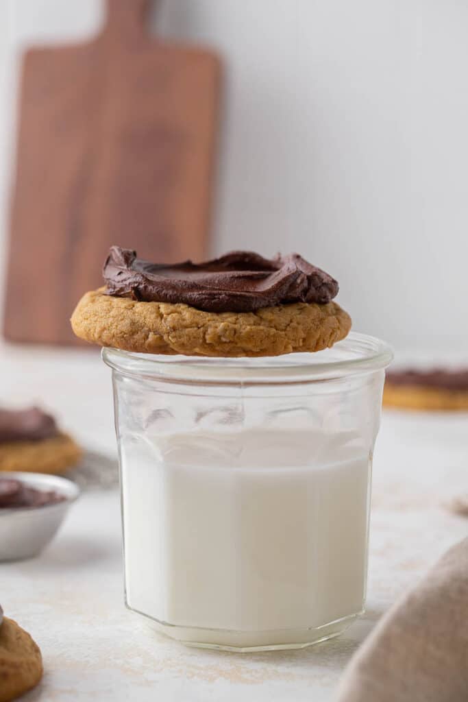 Cookie on top of a glass of milk