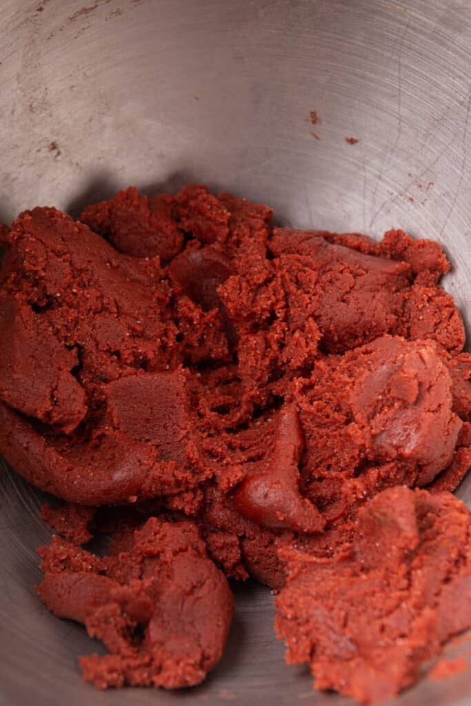 Red velvet cookie dough in mixing bowl