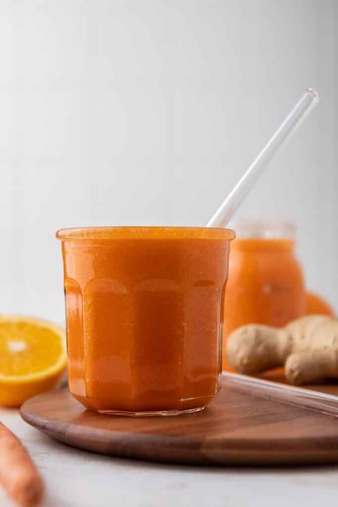 Orange carrot smoothie in a cup