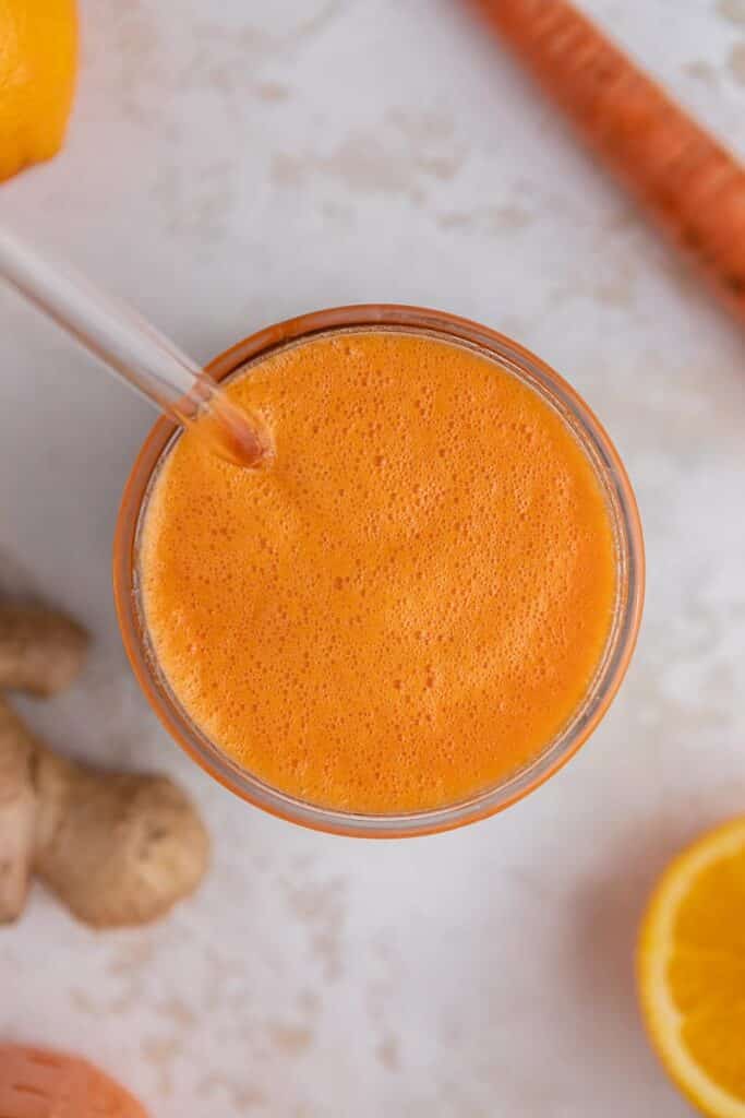 Overhead ginger carrot orange smoothie in a glass