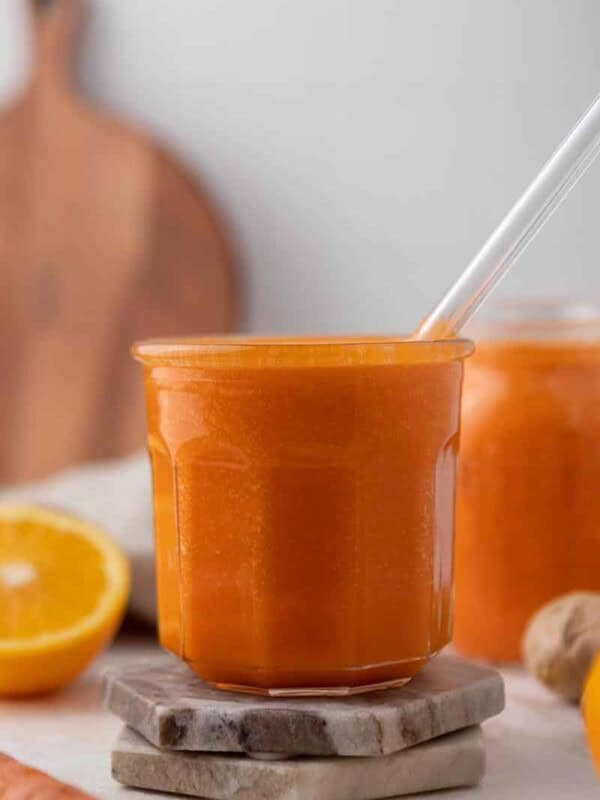 Bright orange smoothie in a glass