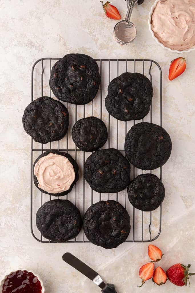 Black cookies with strawberry frosting