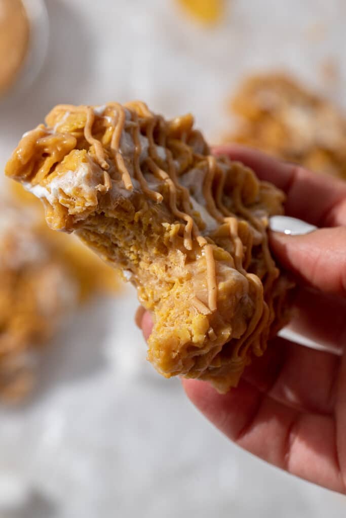Hand holding cornflakes marshmallow cookies