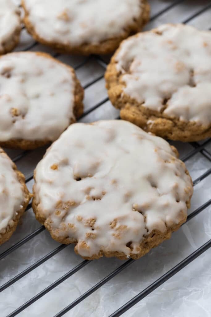 iced oatmeal cookies on cooling rack