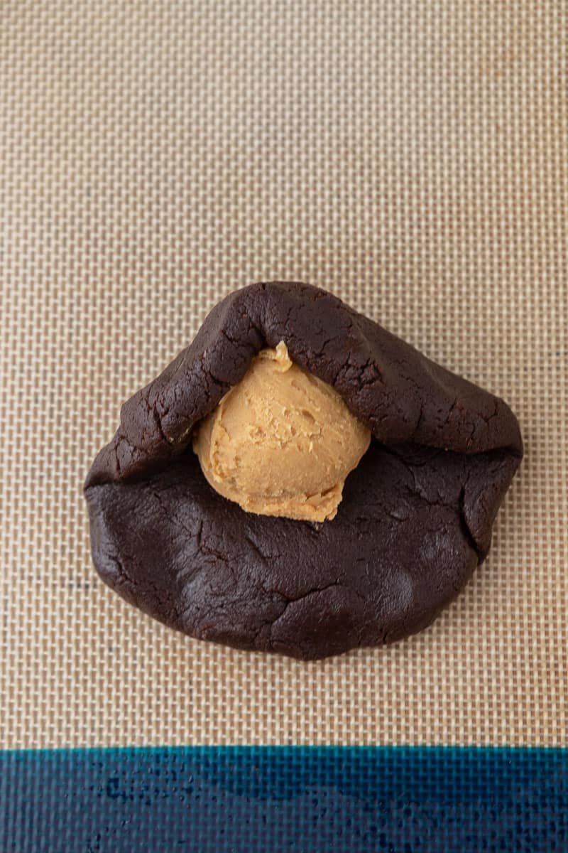 Chocolate cookie dough with peanut butter filling inside 
