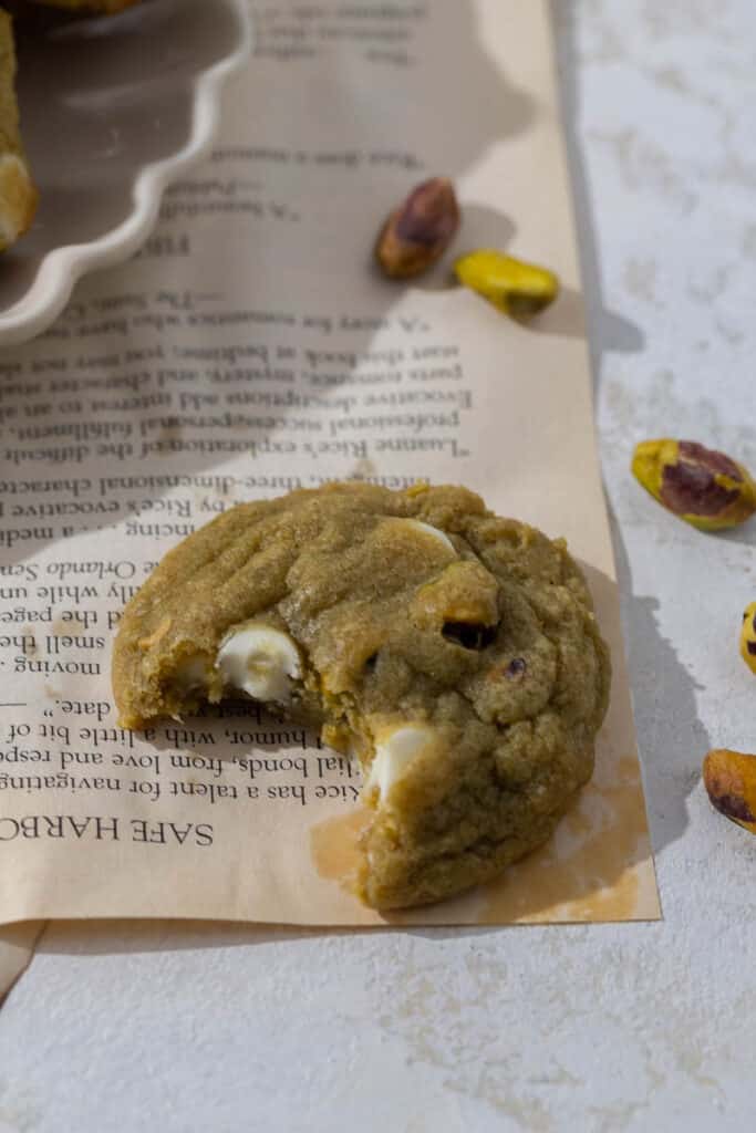 Thick pistachio cookie with a bite taken out of it