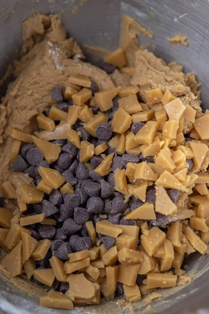 Cookie dough with toffee and chocolate chips in mixing bowl