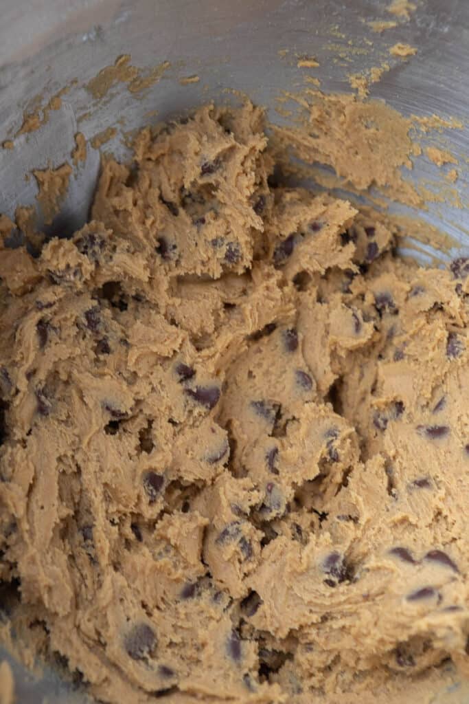 Cookie dough with toffee and chocolate chips in mixing bowl