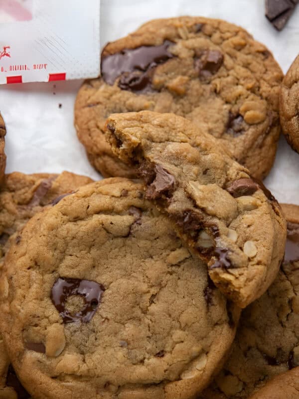Copycat Chick Fil A cookies with one broken open to show melted chocolate chunks.