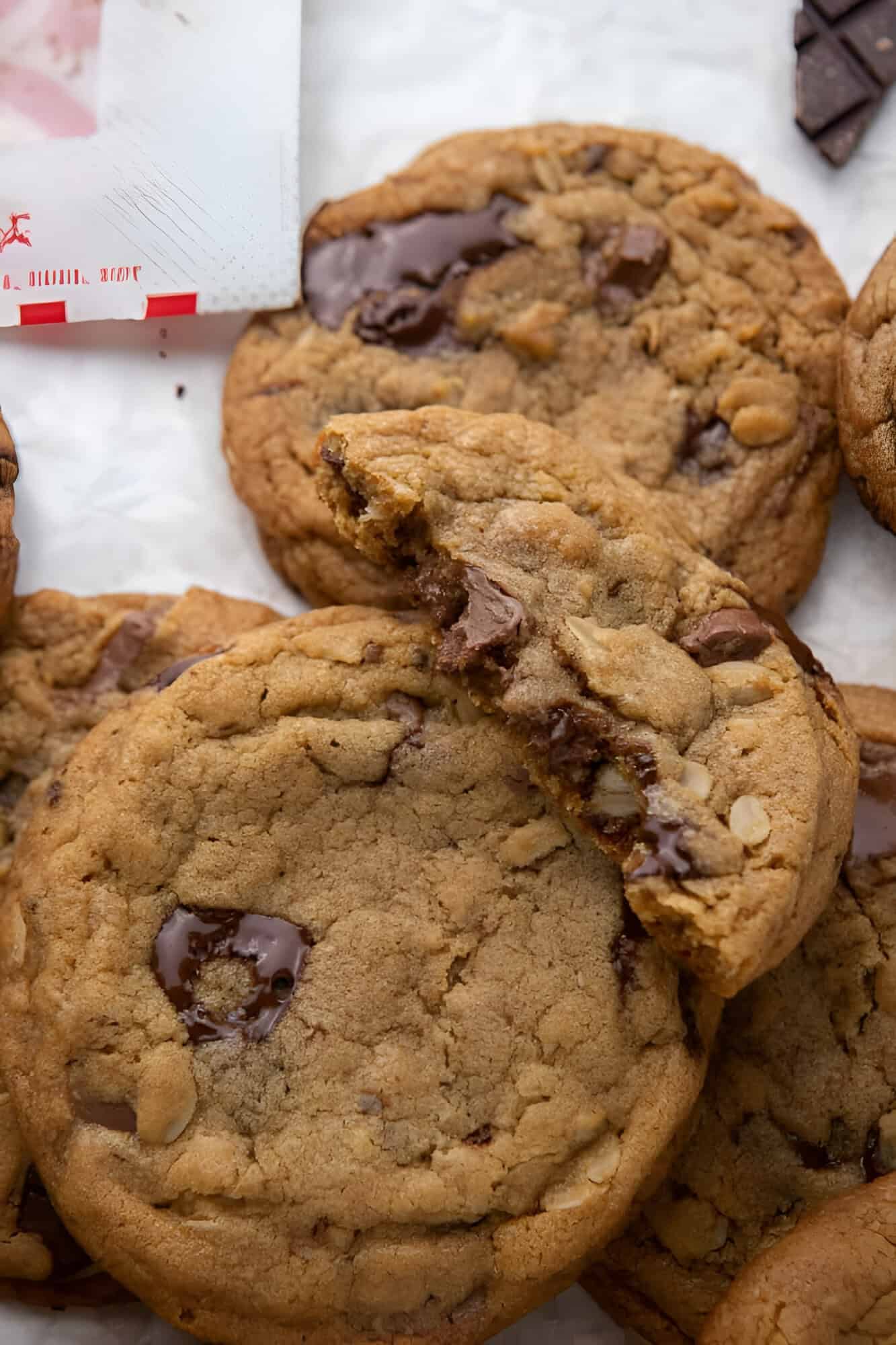 Copycat Chick Fil A cookies with one broken open to show melted chocolate chunks.