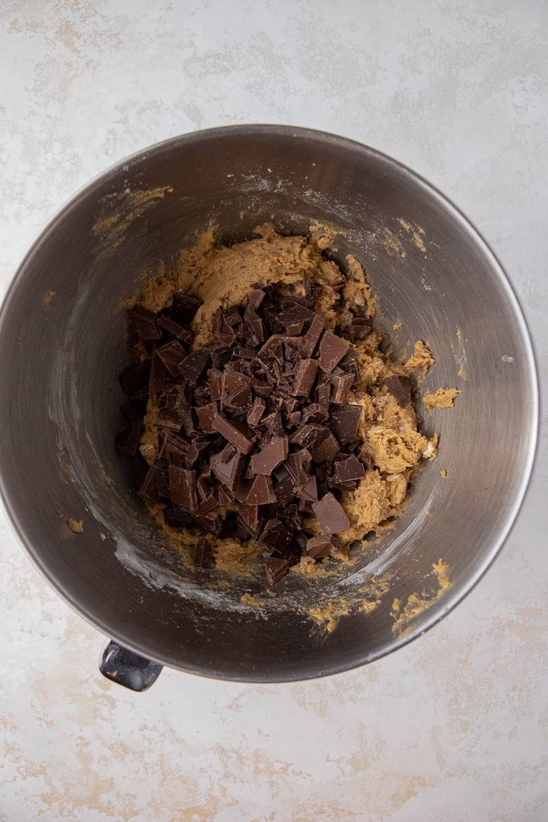 Cookie dough with chocolate chunks in mixing bowl