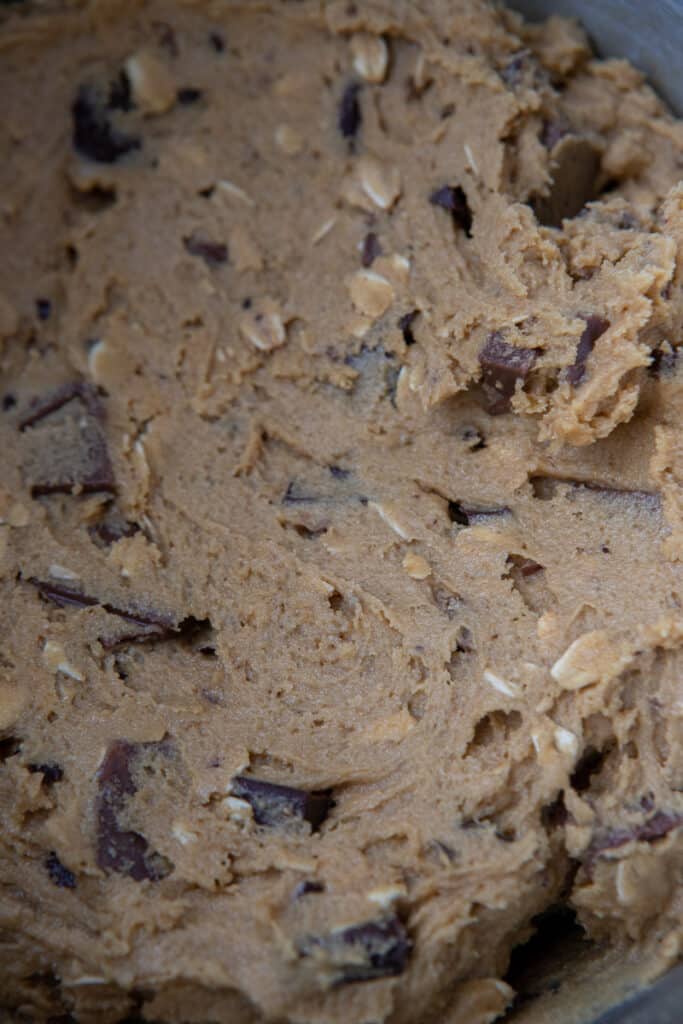 Cookie dough showing the old fashioned oats and milk and semi sweet chocolate chunks throughout.