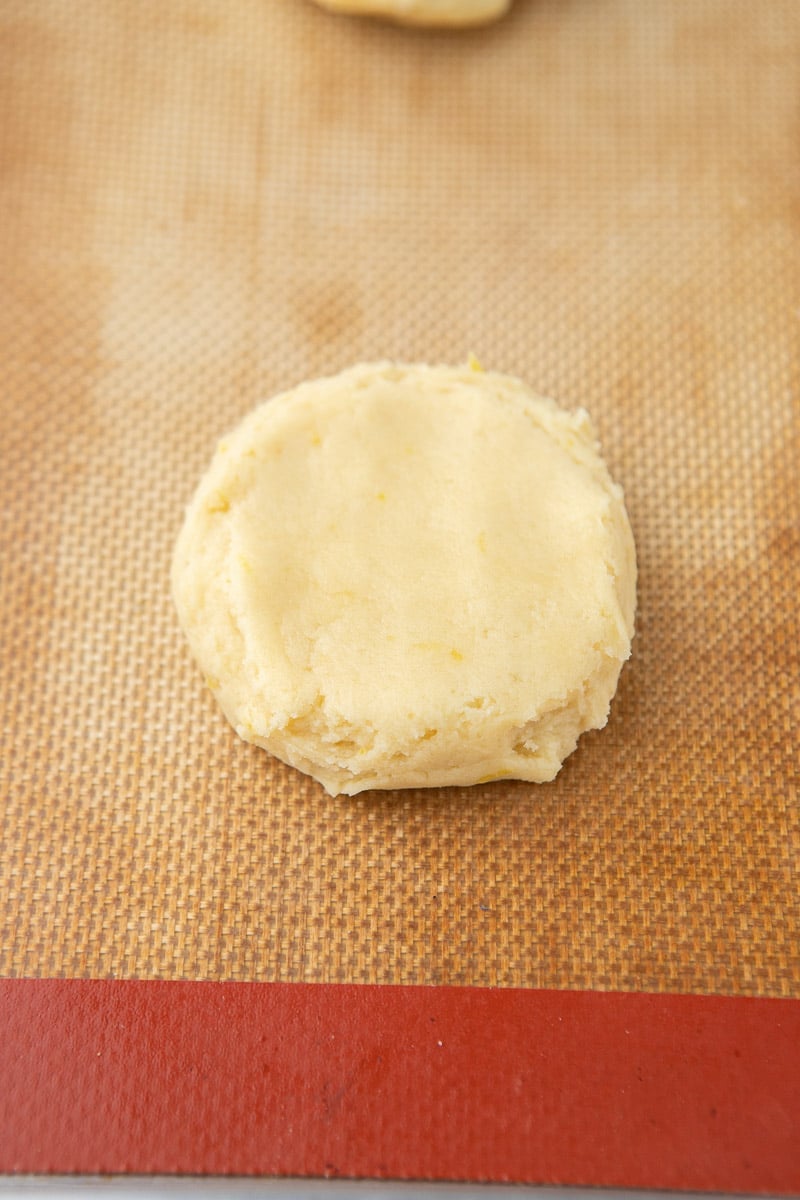 flattened cookie dough on baking sheet 