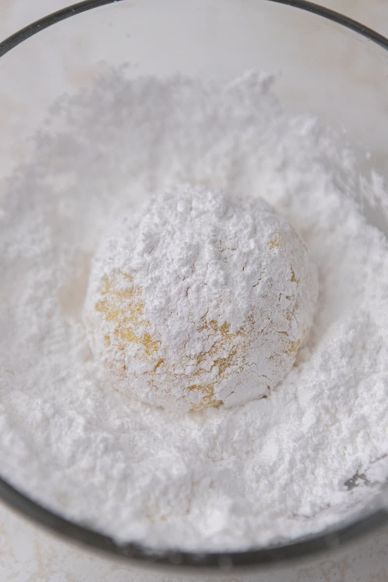 Lemon cookie dough rolled in powdered sugar