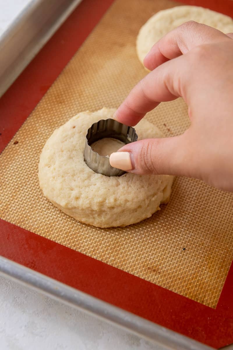 Hand cutting cookie in the center