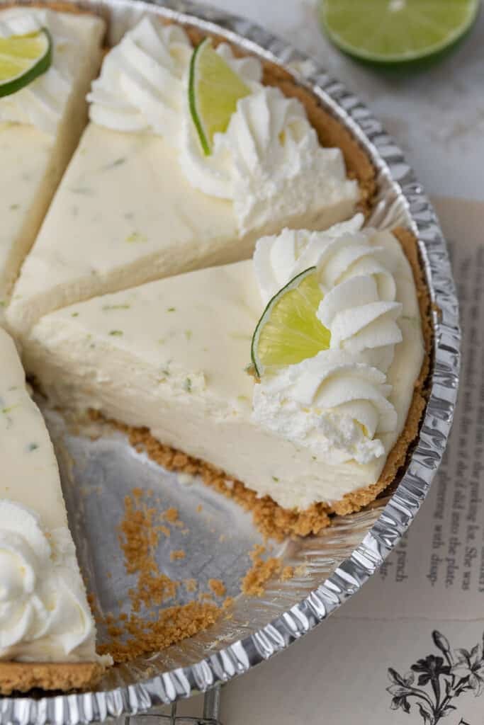 Slice of no bake key lime pie in a pie plate