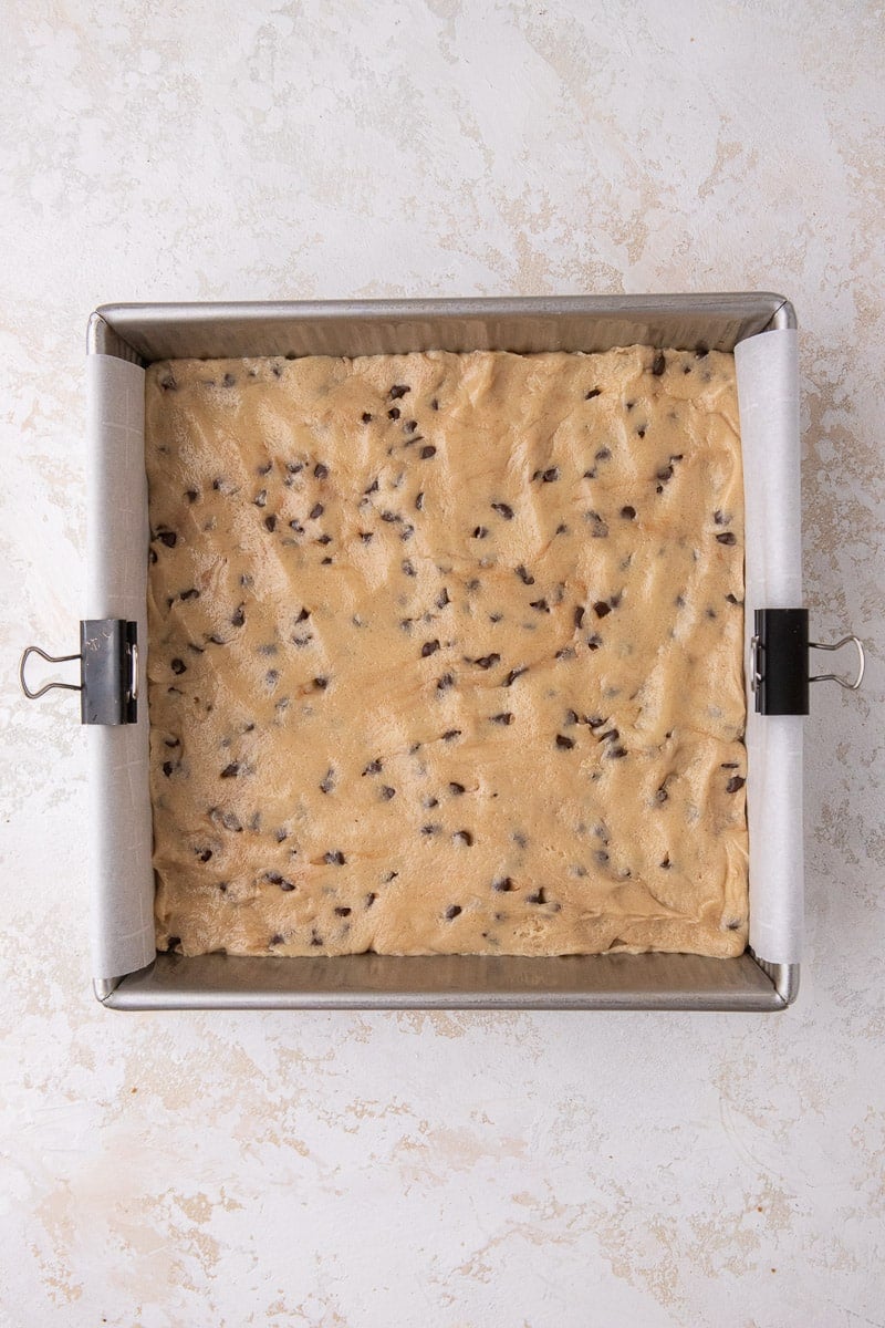 cookie dough in a square baking pan