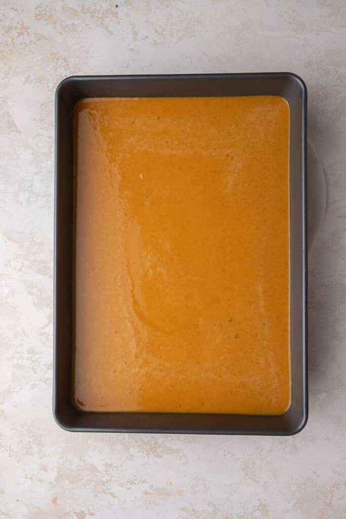 The smooth pumpkin custard poured into a greased nine by thirteen inch baking pan before layering.