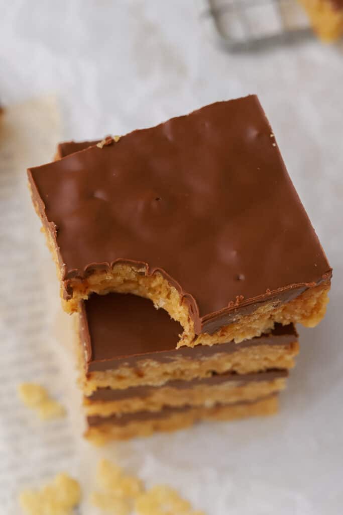 Stack of Scotcheroos with thick chocolate layer on top