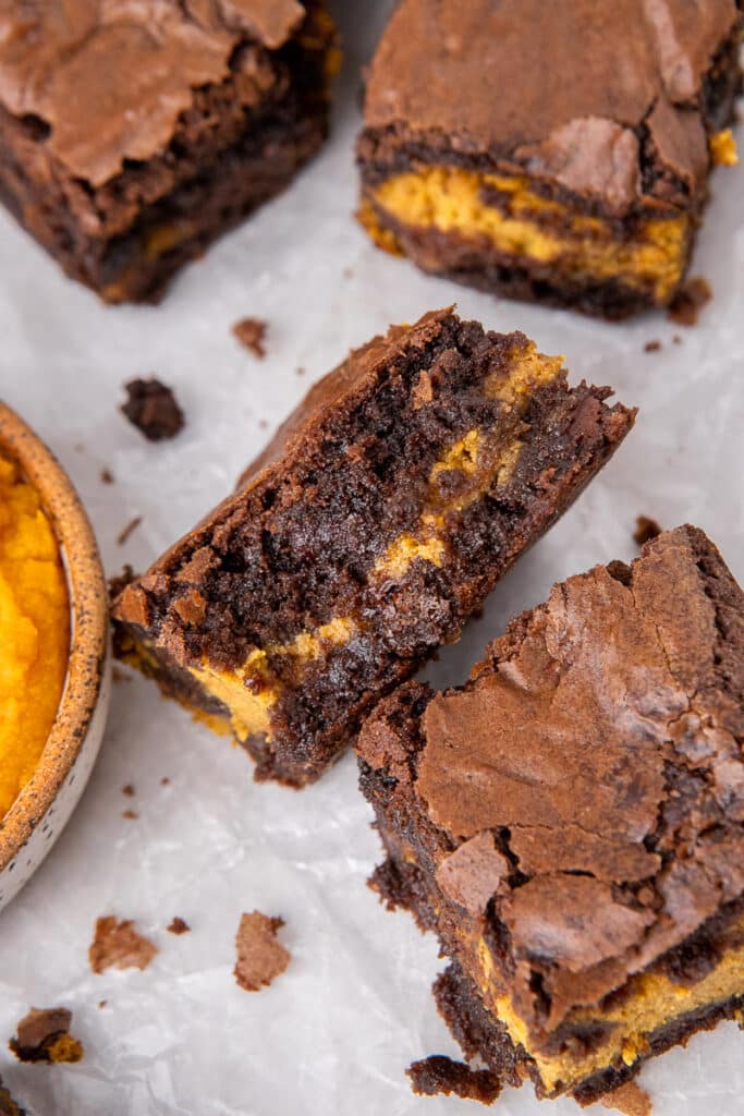 pumpkin cheesecake brownie with a bite taken out of it