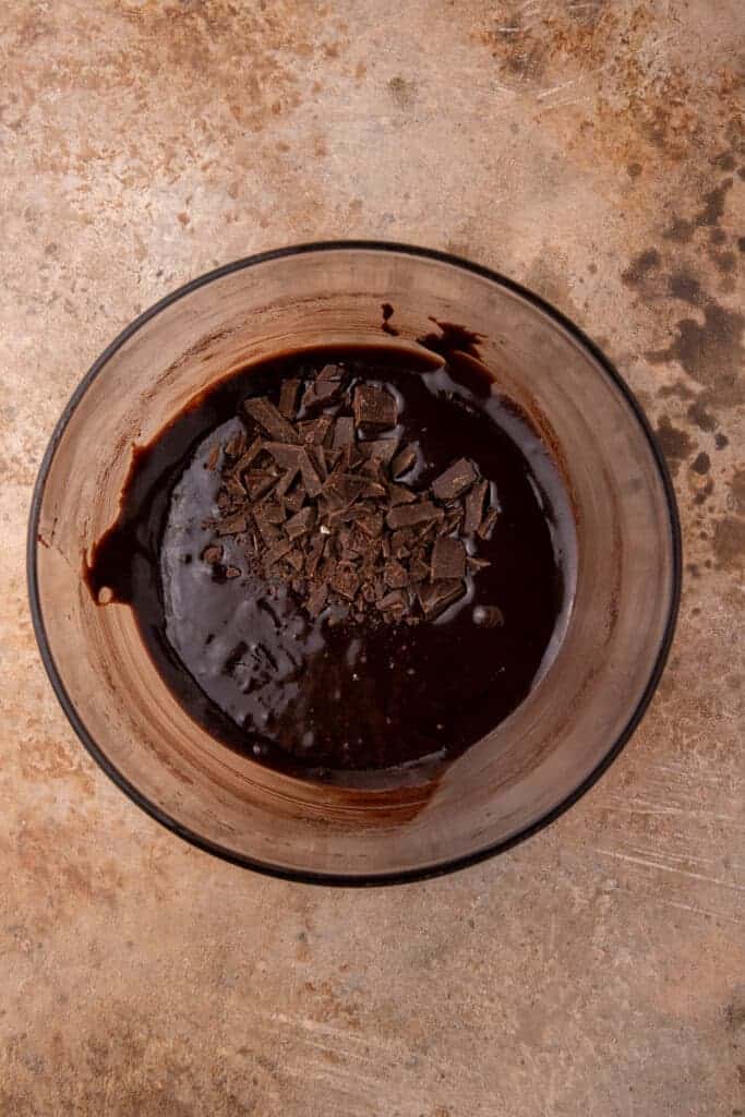 Chopped chocolate chunks folded through the thick cocoa brownie batter before it goes in the pan.