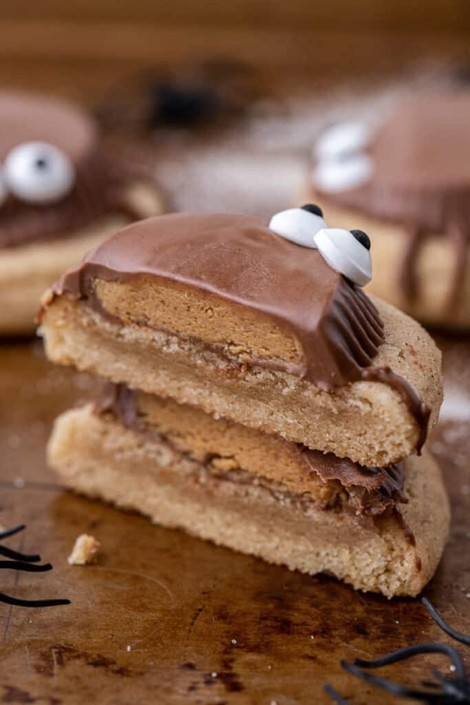 Spooky peanut butter cup cookies sliced in half and stacked