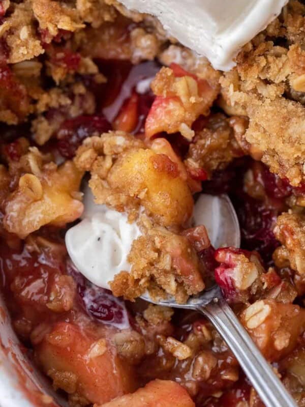 Spoon of cranberry apple crisp and ice cream