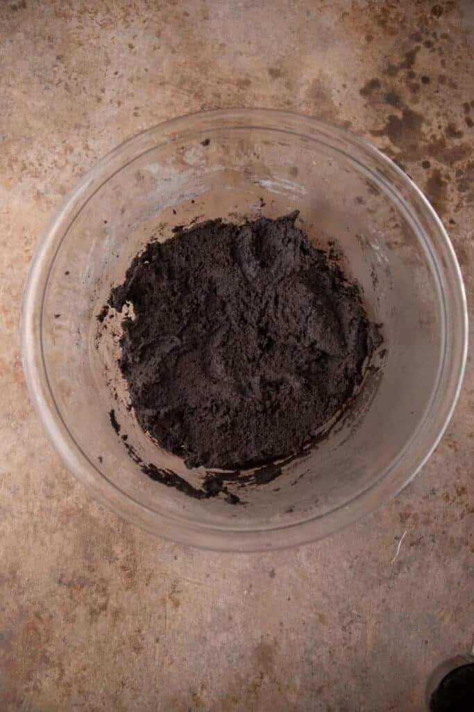 Black cocoa powder cookie dough in a bowl