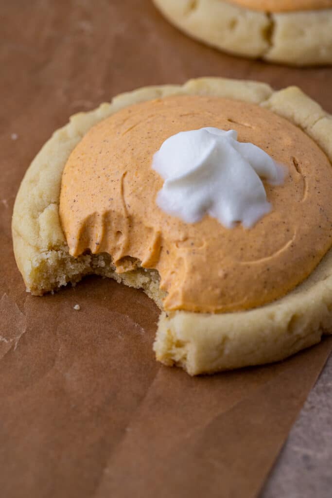 Close up of Crumbl pumpkin pie cookie with a bite taken out of it