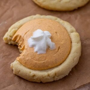 Crumbl pumpkin pie cookie with a bite taken out of it