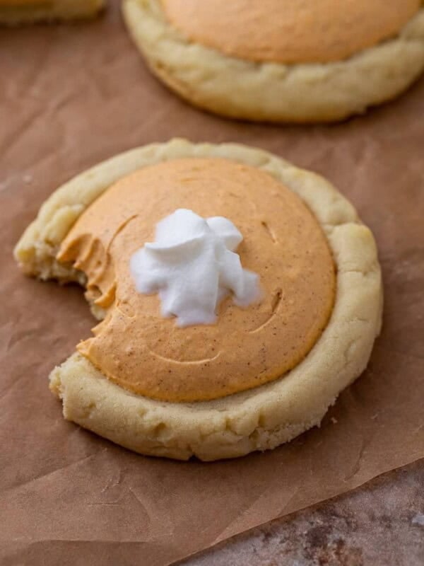 Crumbl pumpkin pie cookie with a bite taken out of it