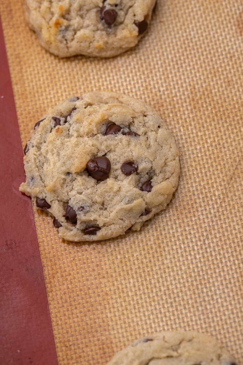 Chewy eggless chocolate chip cookie on a baking sheet