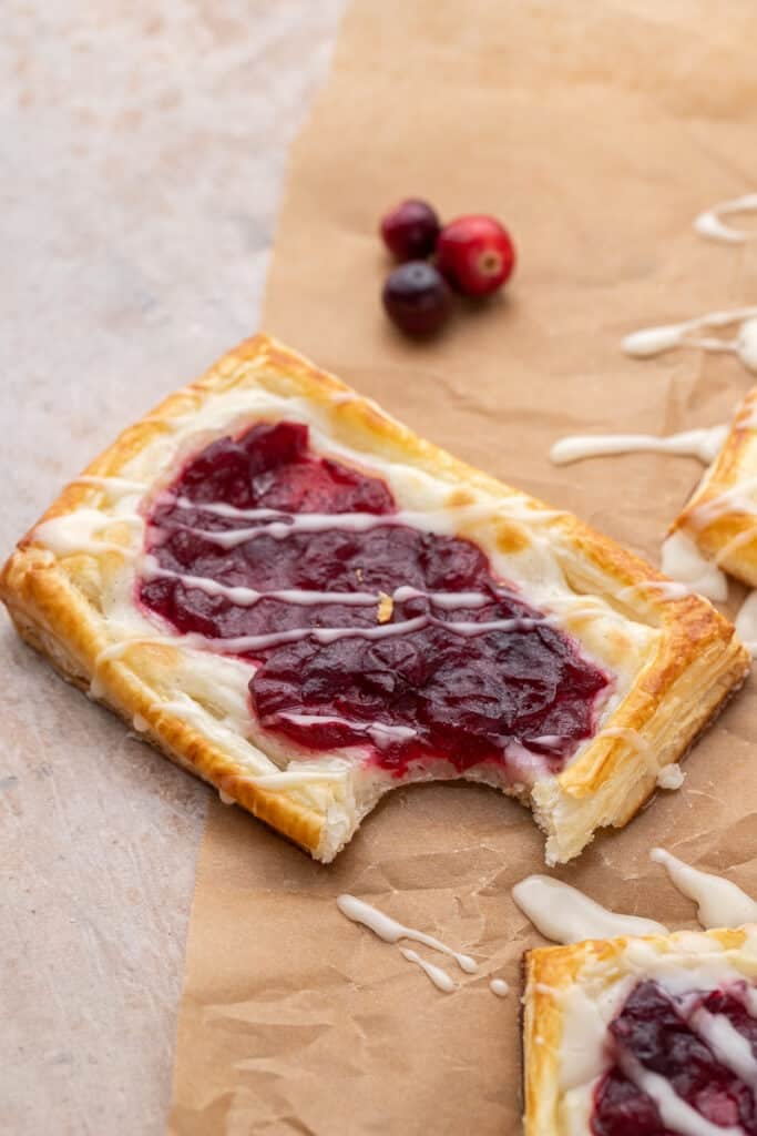 Cranberry sauce cheese danish with a bite taken out of it