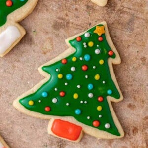 Decorated Christmas tree sugar cookie made with glossy green icing and colorful sprinkles.