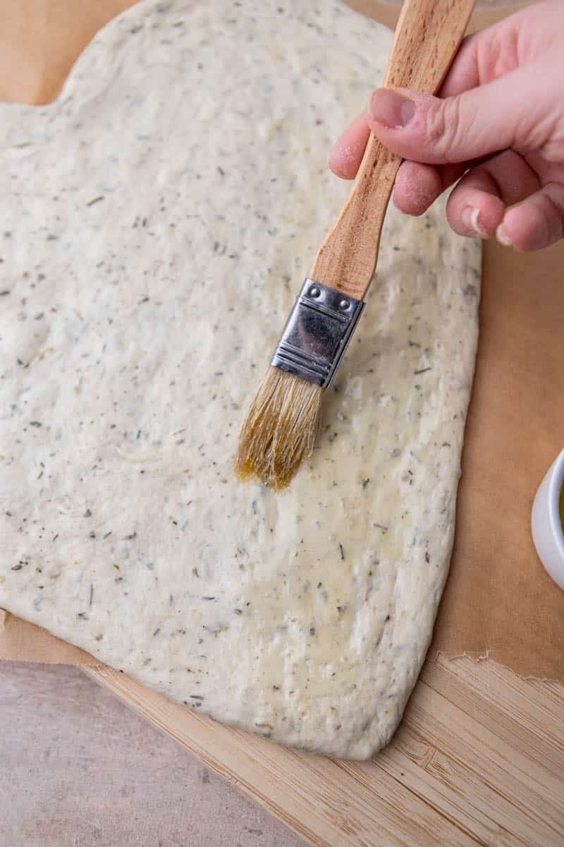 Brushing olive oil in pizza dough