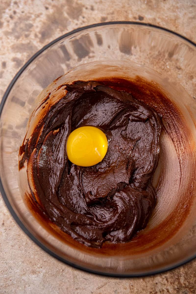 Melted chocolate with egg yolk in a bowl