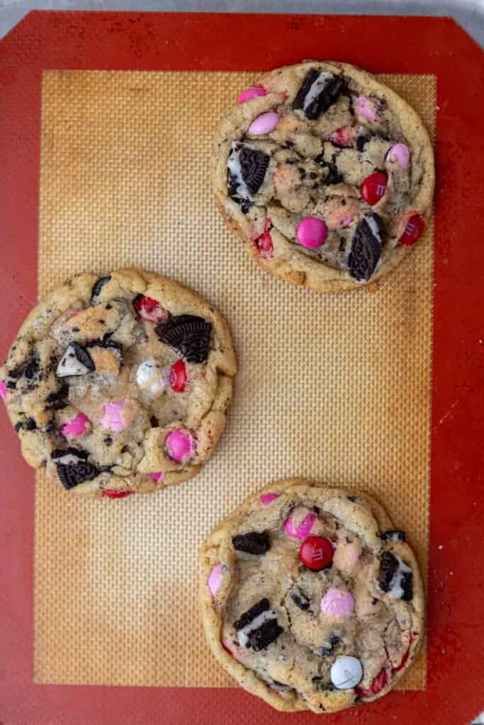 Freshly baked Valentine’s Day Oreo M&M cookies on baking sheet