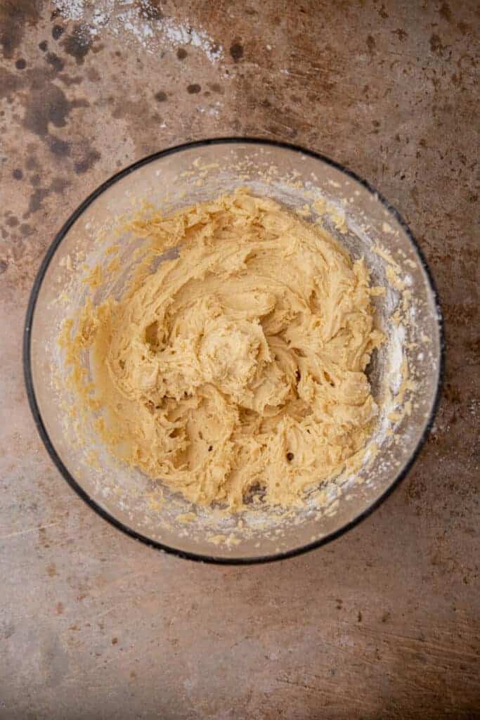 Fully mixed cookie dough in a glass bowl