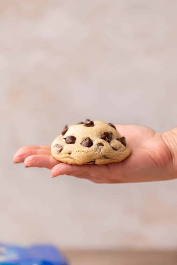Hand holding thick Oreo stuffed chocolate chip cookies