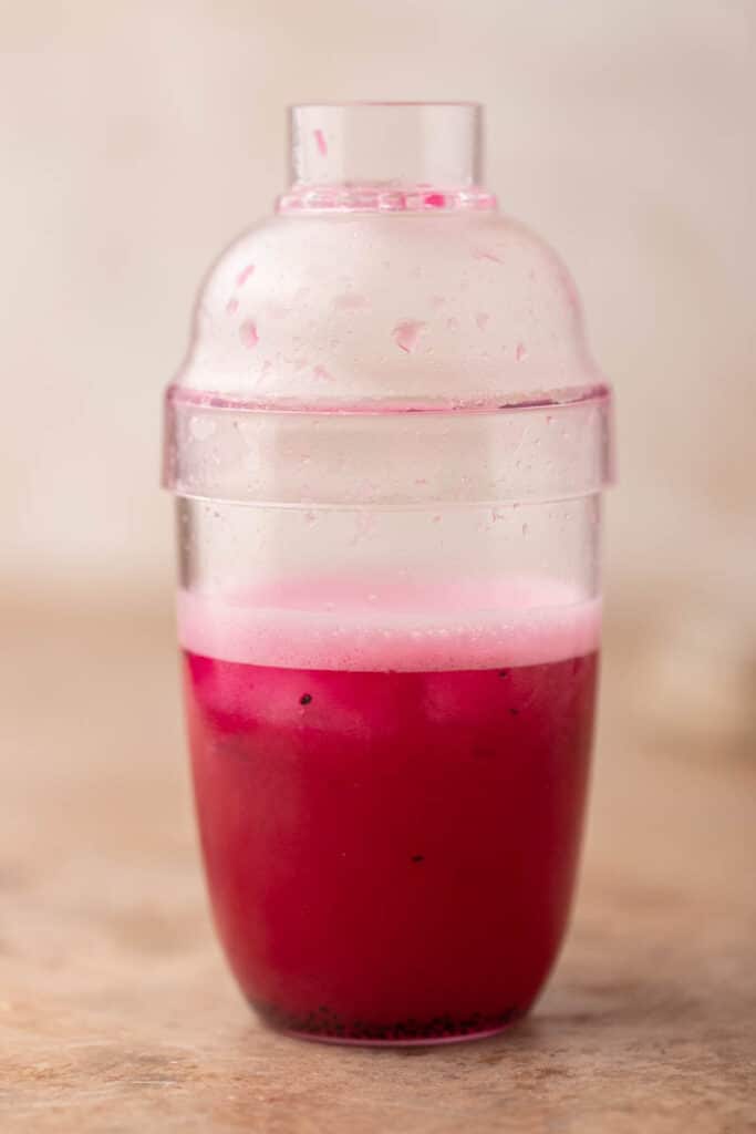 Pink drink mixed inside a shaker bottle